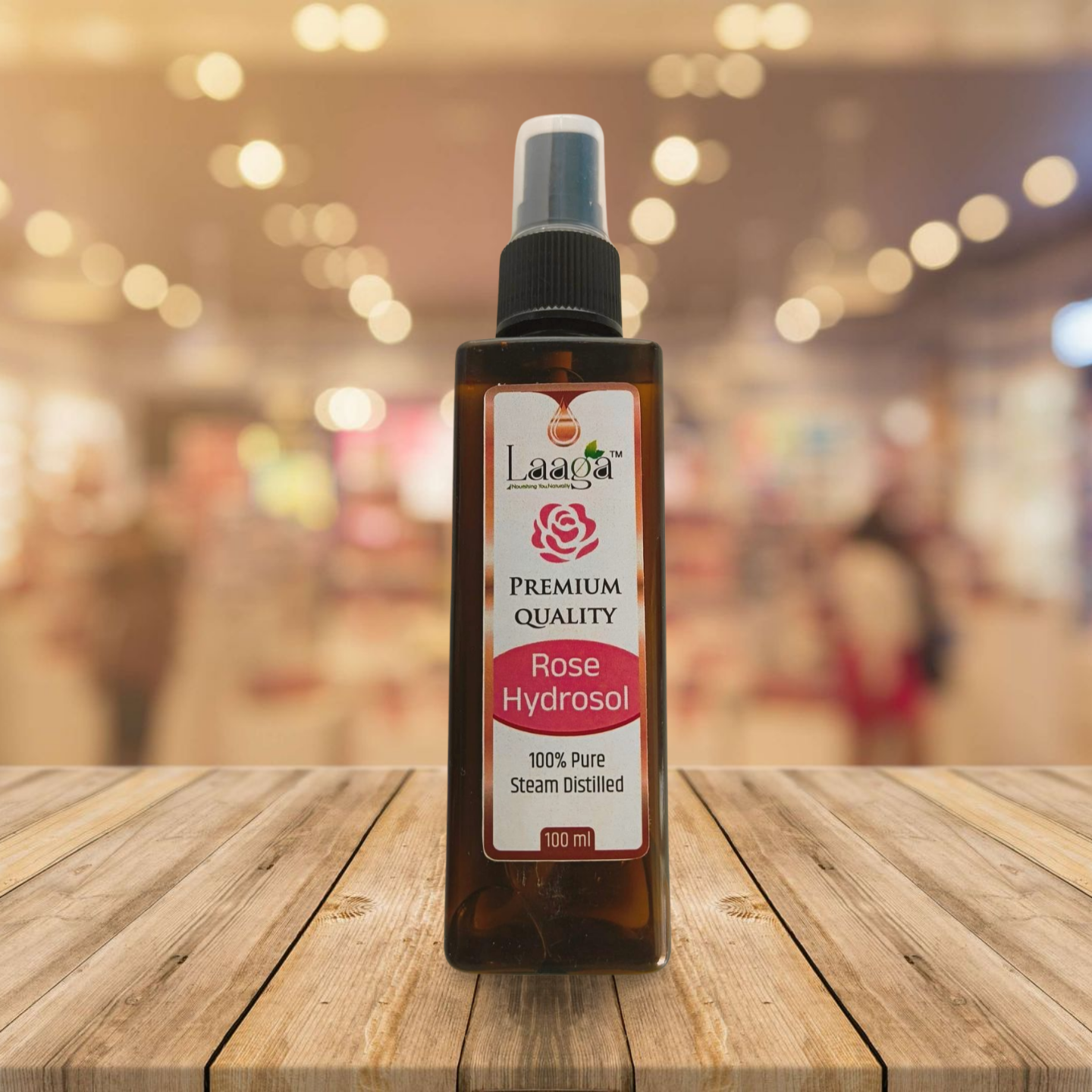 Bottle of Rose Hydrosol on a wooden surface with a blurred background